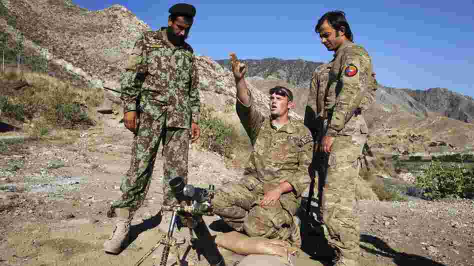 Spc. Ben Purvis (center) helps train Afghan troops on how to use mortars in the eastern province of Kunar in June. The top U.S. commander in Afghanistan, Gen. John Allen, points to several factors in the rise of "insider attacks" on American forces. He says relations between U.S. and Afghan troops are good overall.