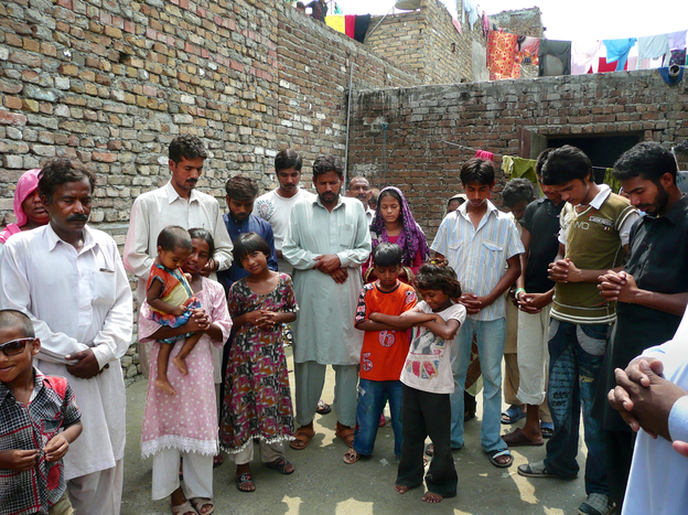 Christians pray for Rimsha on the roof of their priest's compound. Hundreds of the girl's Christian neighbors have fled their homes, fearing attacks by Muslims.