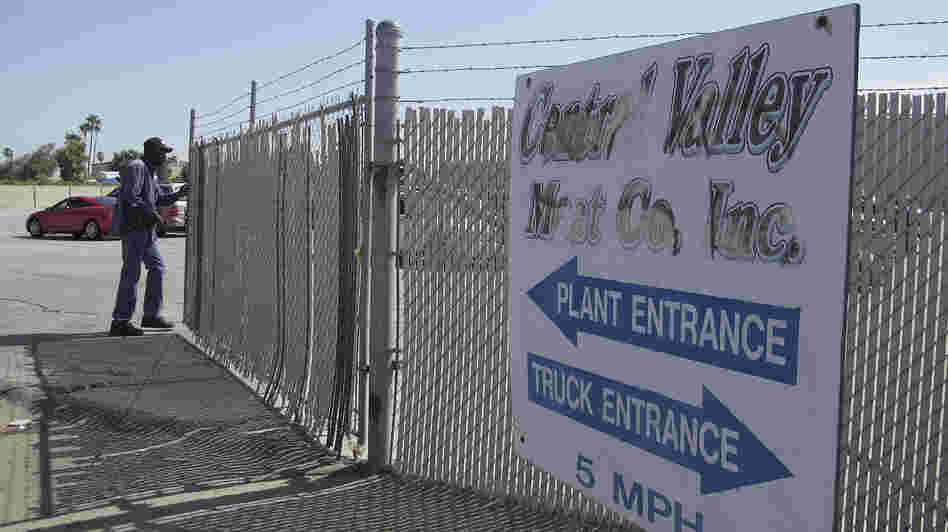 A security guard opens the gate at the Central Valley Meat Co., the California slaughterhouse recently shut down by federal regulators after they received a graphic video of cows being mistreated.