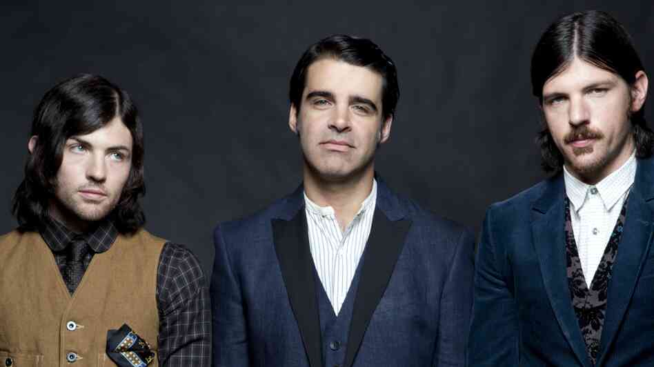 The Avett Brothers are real-life siblings Scott (left) and Seth Avett (right), and bass player Bob Crawford. The band's newest album is The Carpenter.