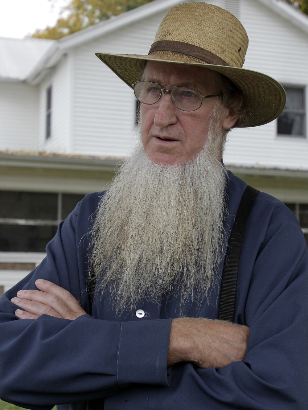 Sam Mullet, in the front yard of his home in Bergholz, Ohio, last year, is one of 16 people charged in beard- and hair- cutting attacks on fellow Amish. Mullet denies being involved in the attacks.