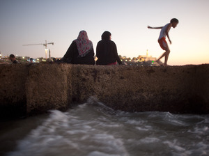 Many West Bank Palestinians allowed into Israel in recent weeks headed to the Mediterranean shore. Here, Palestinians enjoy a day at a beach on Aug. 21. Many West Bank Palestinians allowed into Israel in recent weeks headed to the Mediterranean shore. Here, Palestinians enjoy a day at a beach on Aug. 21.