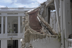 A ruined staircase is seen in the collapsed National Palace. Parker described it as "a staircase of grandeur."