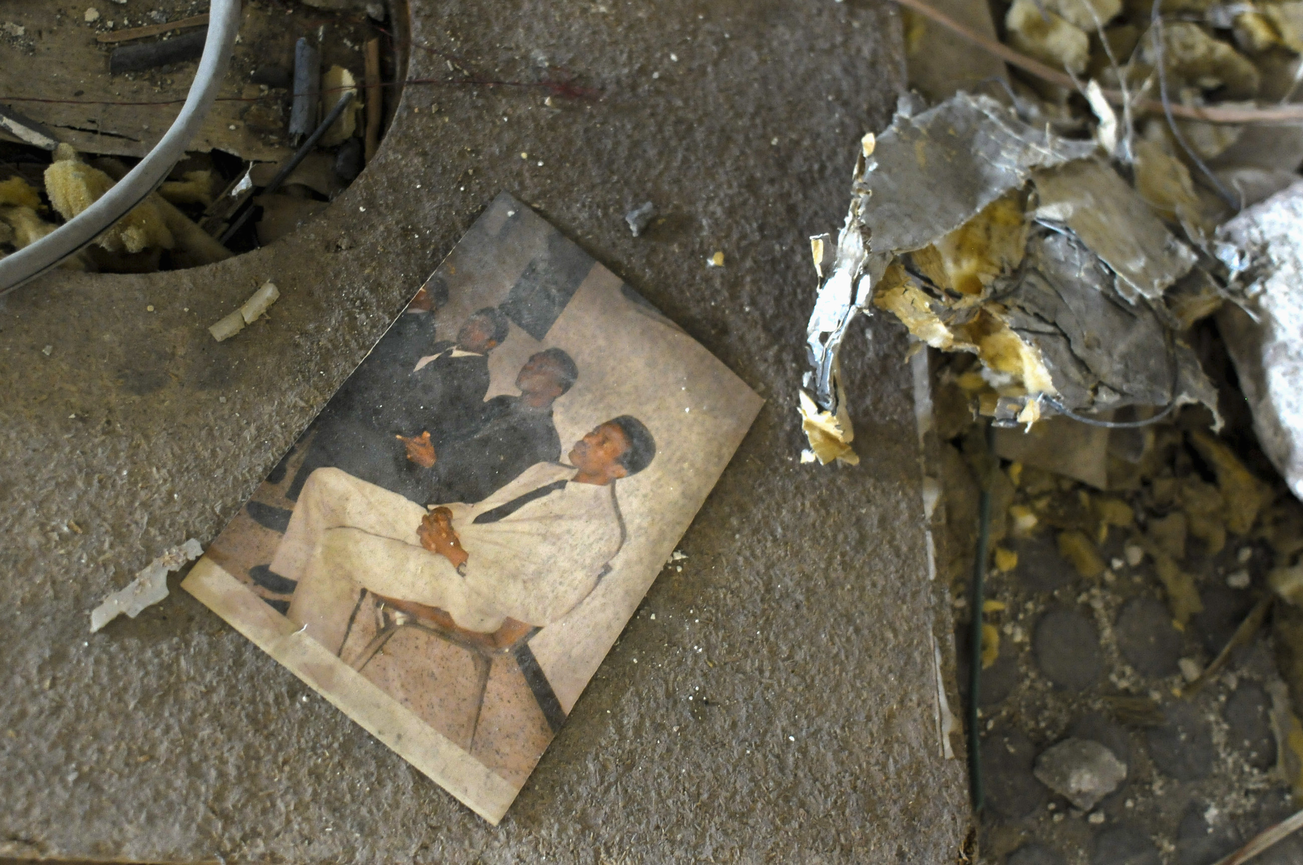 A photograph lies amid the rubble.