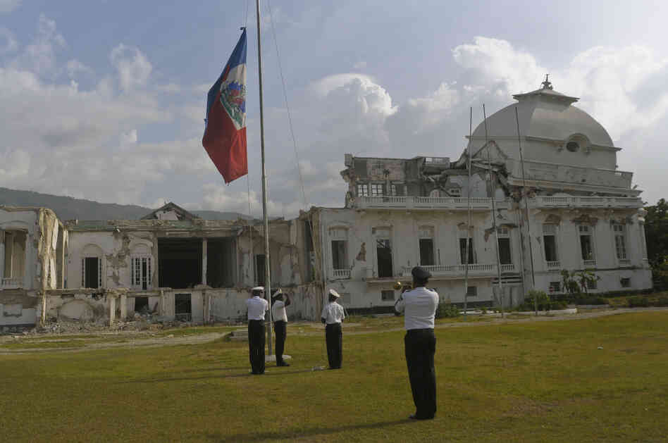 Members of the Haitian Color Guard lower the flag in front of the National Palace on Aug. 9.