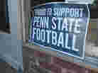 Signs on display around town are designed to show support for Penn State's football team as a new season begins.