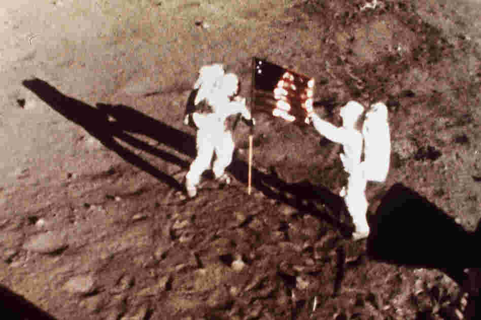 On July 20, 1969, Apollo 11 astronauts Armstrong and Aldrin, the first men to land on the moon, plant the U.S. flag on the lunar surface.