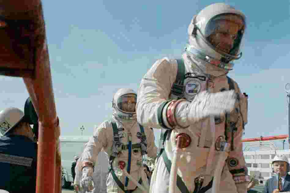 Commander Neil Armstrong (right) and pilot David R. Scott prepare to board the Gemini-Titan VIII. Gemini VIII successfully launched March 16, 1966. The mission conducted the first docking of two spacecraft in orbit and landed safely back on Earth after an emergency abort.