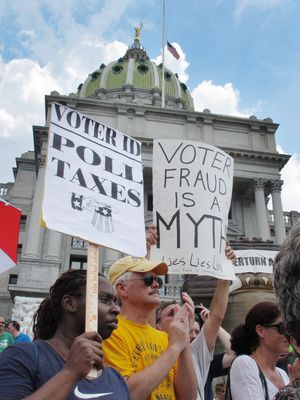 Demonstrators hold signs at an NAACP-organized rally on the steps of the Pennsylvania Capitol to protest the state's new voter identification law on July 24 in Harrisburg, Pa. Demonstrators hold signs at an NAACP-organized rally on the steps of the Pennsylvania Capitol to protest the state's new voter identification law on July 24 in Harrisburg, Pa.