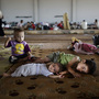 Syrian children, who fled their home with their family, take refuge at the Bab Al-Salameh border crossing, in hopes of entering one of the refugee camps in Turkey on Sunday.