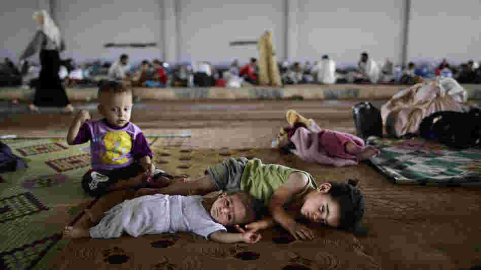 Syrian children, who fled their home with their family, take refuge at the Bab Al-Salameh border crossing, in hopes of entering one of the refugee camps in Turkey on Sunday. Syrian children, who fled their home with their family, take refuge at the Bab Al-Salameh border crossing, in hopes of entering one of the refugee camps in Turkey on Sunday.