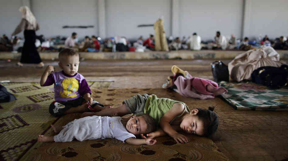 Syrian children, who fled their home with their family, take refuge at the Bab Al-Salameh border crossing, in hopes of entering one of the refugee camps in Turkey on Sunday. Syrian children, who fled their home with their family, take refuge at the Bab Al-Salameh border crossing, in hopes of entering one of the refugee camps in Turkey on Sunday.
