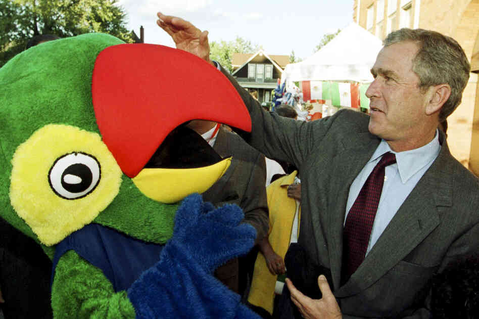 During his first bid for the White House, then-Texas Gov. George W. Bush joked around with a person in a parrot costume at a Mexican independence festival in Detroit, Ill., in September 1999.