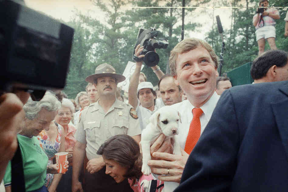 Republican vice presidential candidate Dan Quayle holds a puppy during a campaign appearance in Newnan, Ga., in 1988.