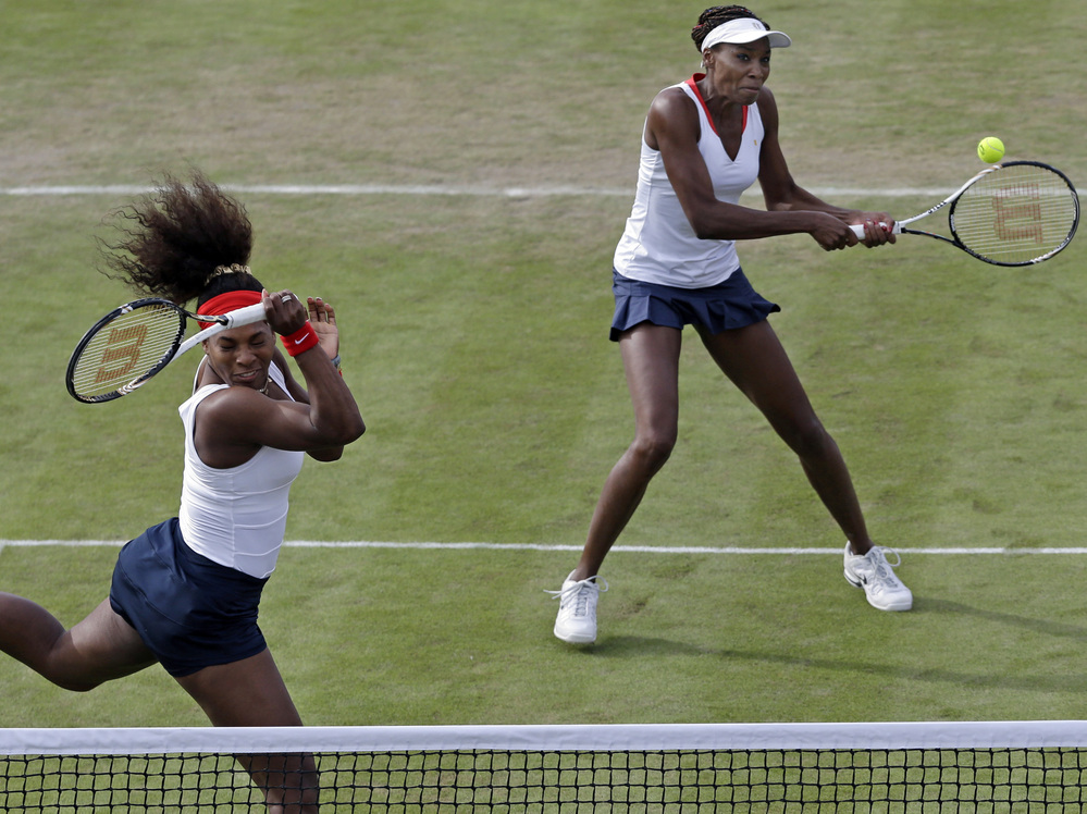 Serena Williams, left, and Venus Williams compete in Wimbledon at the 2012 Summer Olympics.
