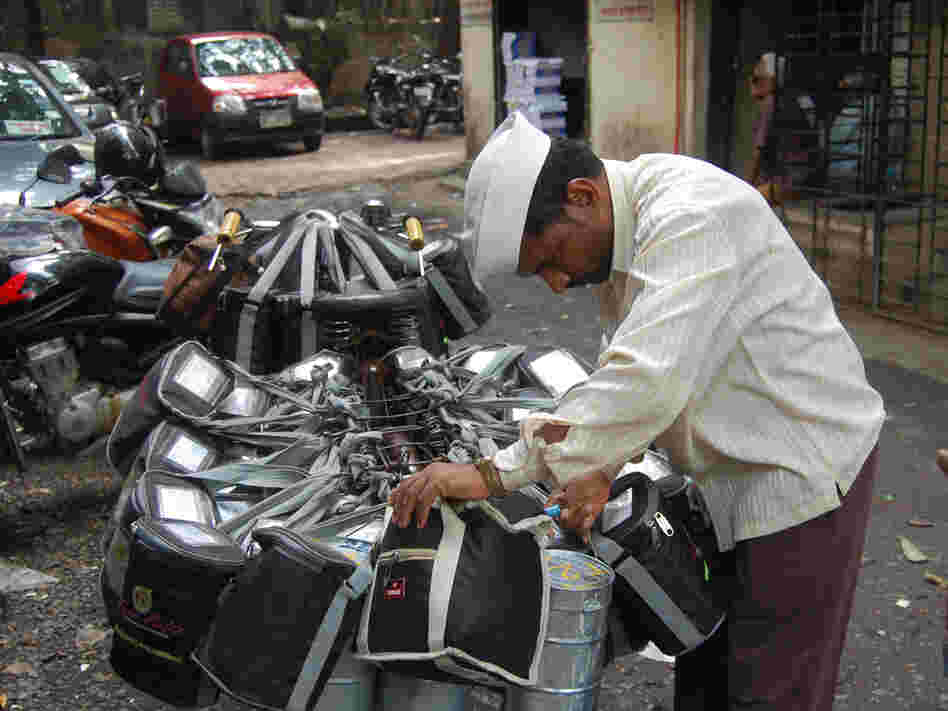 A dabba wallah checks his packages before delivering hot meals to office workers in Mumbai.