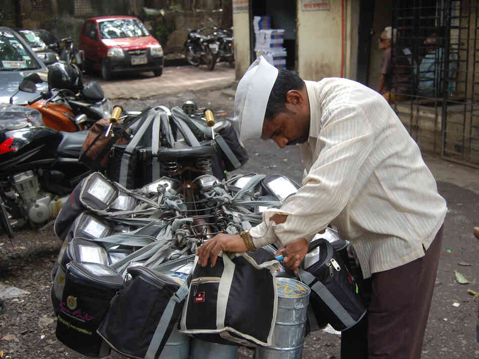 A dabba wallah checks his packages before delivering hot meals to office workers in Mumbai.