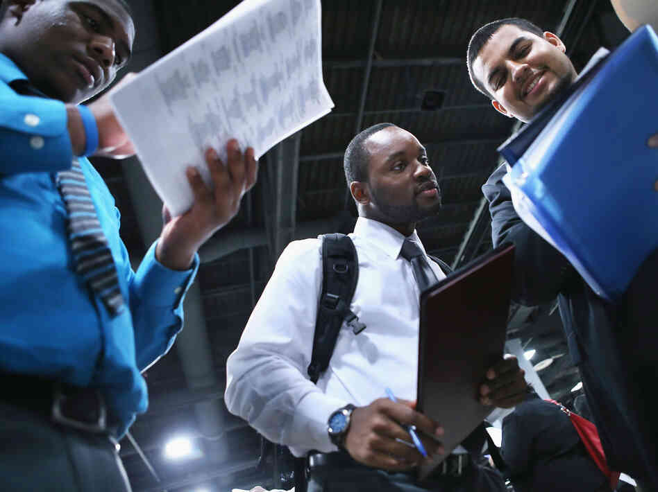 Young job-seekers look over a list of 85 business participating in a job fair last week in Washington, D.C.