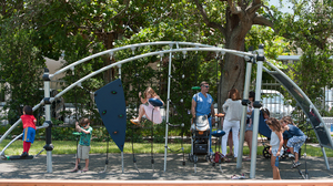 Children play at the 1814 Brickell Park, a new park that features benches, a paved path and a monument made of a girder from the World Trade Center.