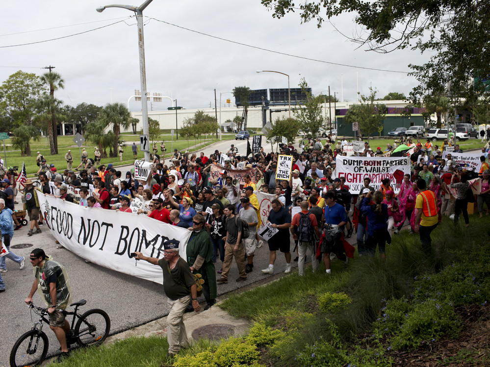 Turnout for Monday's protest rally and march in downtown Tampa was much lower than expected and rain drenched the crowd.
