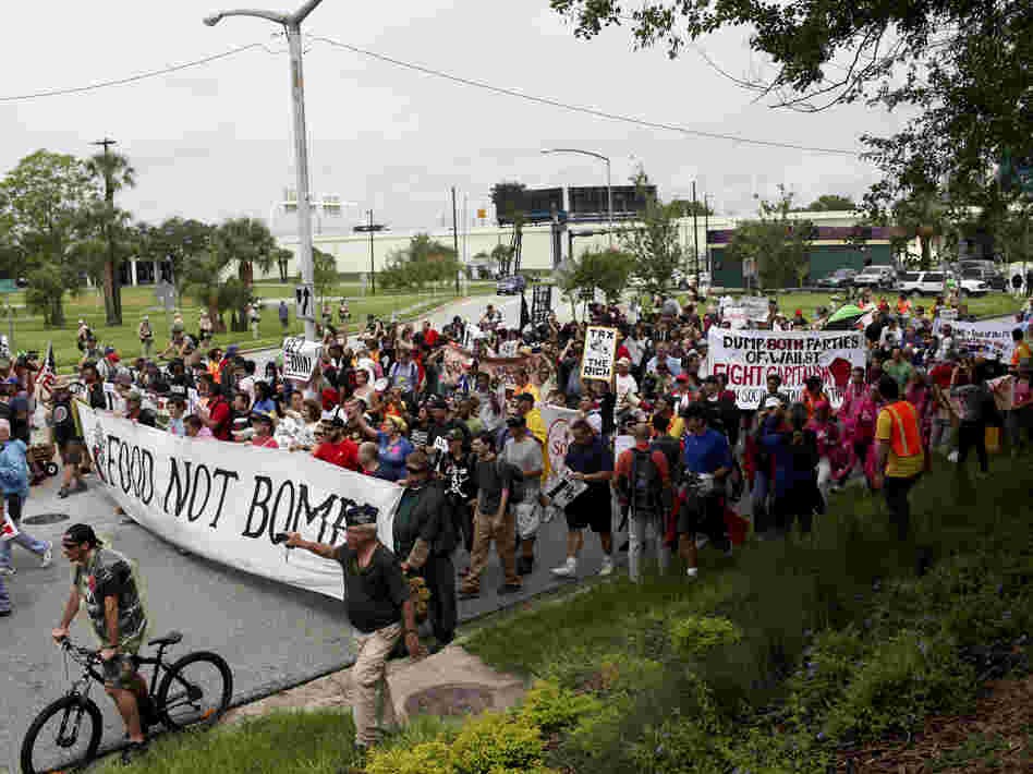 Turnout for Monday's protest rally and march in downtown Tampa was much lower than expected and rain drenched the crowd.
