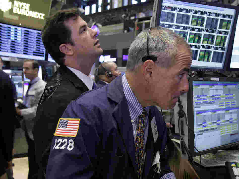 Traders work on the floor of the New York Stock Exchange. The Dow Jones industrial average is nearly back to where it was before the recession hit in 2007.