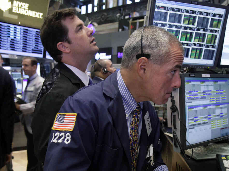 Traders work on the floor of the New York Stock Exchange. The Dow Jones industrial average is nearly back to where it was before the recession hit in 2007.