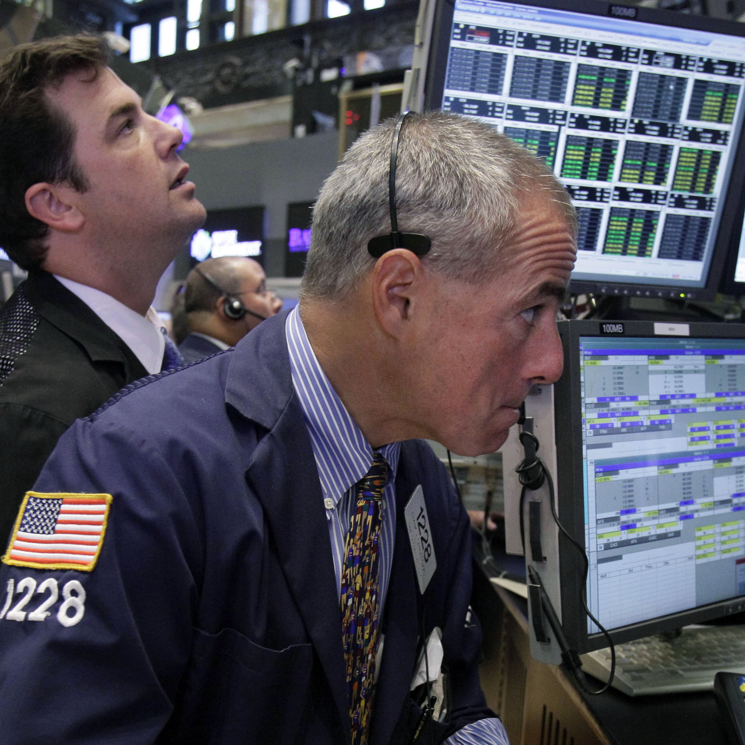 Traders work on the floor of the New York Stock Exchange. The Dow Jones industrial average is nearly back to where it was before the recession hit in 2007.