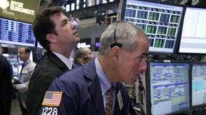 Traders work on the floor of the New York Stock Exchange. The Dow Jones industrial average is nearly back to where it was before the recession hit in 2007.