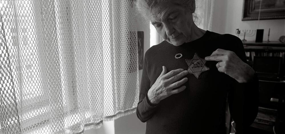 Andula Lorencova, born in 1927, in her apartment with her original yellow star, Prague, June 2012. While her father was "trying to procure official Chinese approval for his family to join him, Andula along with her brother and mother were deported to Terezin."