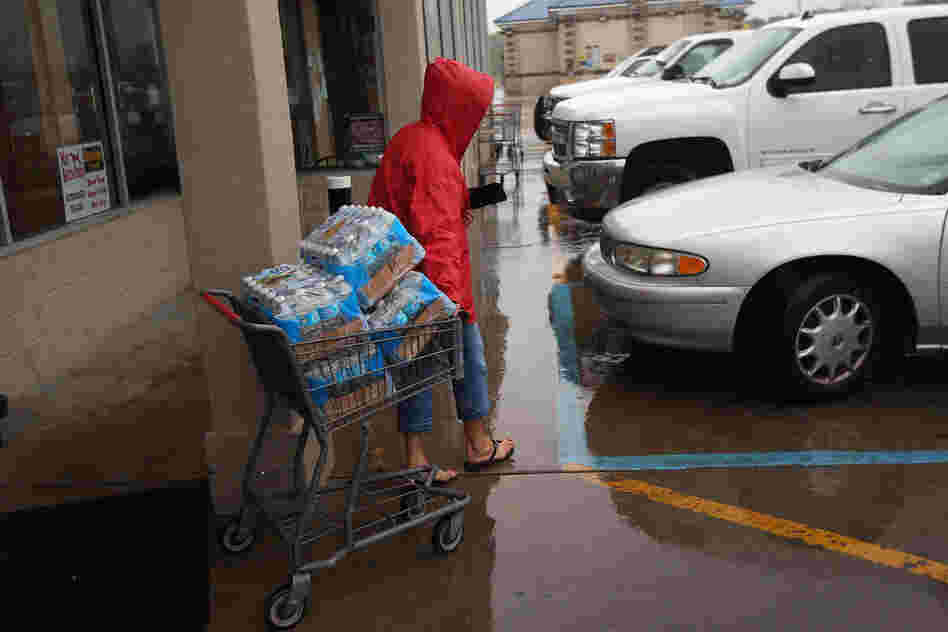 Suzette Necaise stocks up on bottled water at Seal's Marketplace Kiln, Miss. The area suffered severe damage during Hurricane Katrina in 2005.