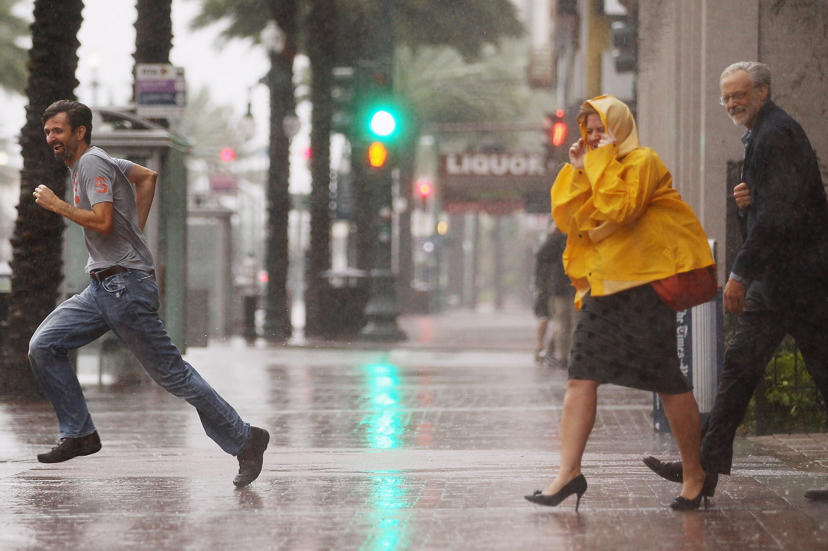People make their way across Canal Street in New Orleans. Ed Rappaport, deputy director of the National Hurricane Center, said Isaac's core would pass west of the city and head for Baton Rouge.