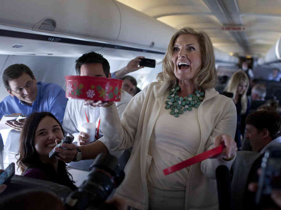 Ann Romney, wife of Republican presidential candidate Mitt Romney, shares her homemade Welsh cakes with reporters on the flight to Tampa on Tuesday.