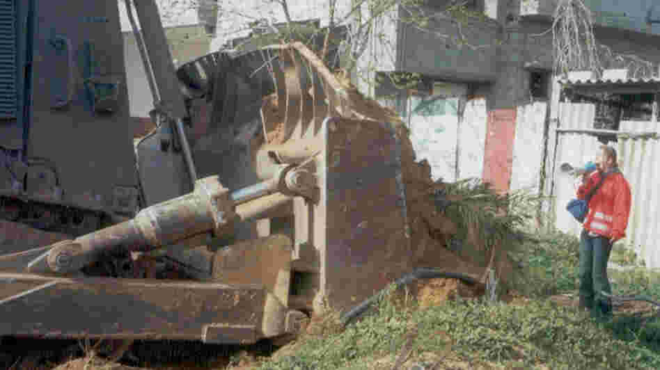 Rachel Corrie, 23, stands in front of a Palestinian's home to prevent it from being demolished Rachel Corrie, 23, stands in front of a Palestinian's home to prevent it from being demolished