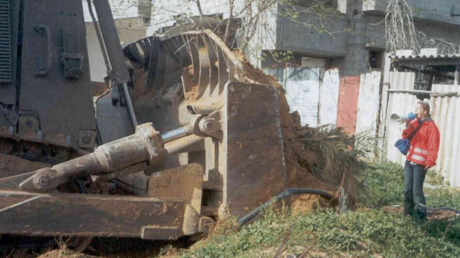 Rachel Corrie, 23, stands in front of a Palestinian's home to prevent it from being demolished Rachel Corrie, 23, stands in front of a Palestinian's home to prevent it from being demolished