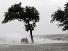 People sit on a bench along the seawall in the storm surge from Isaac, on Lakeshore Drive along Lake Pontchartrain, as the storm approaches landfall, in New Orleans, Tuesday, Aug. 28. People sit on a bench along the seawall in the storm surge from Isaac, on Lakeshore Drive along Lake Pontchartrain, as the storm approaches landfall, in New Orleans, Tuesday, Aug. 28.