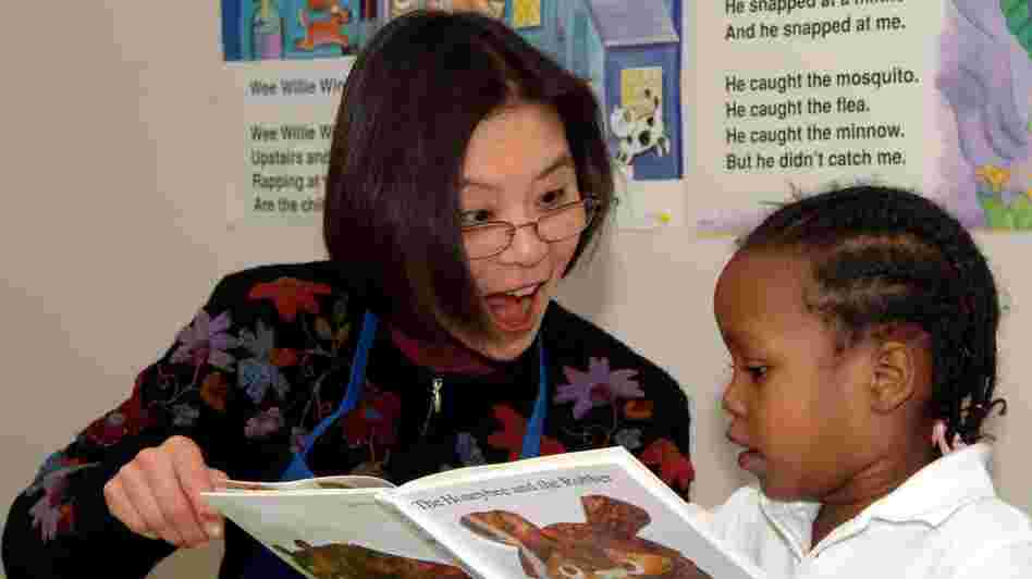A Read Aloud Delaware volunteer reads to a student.