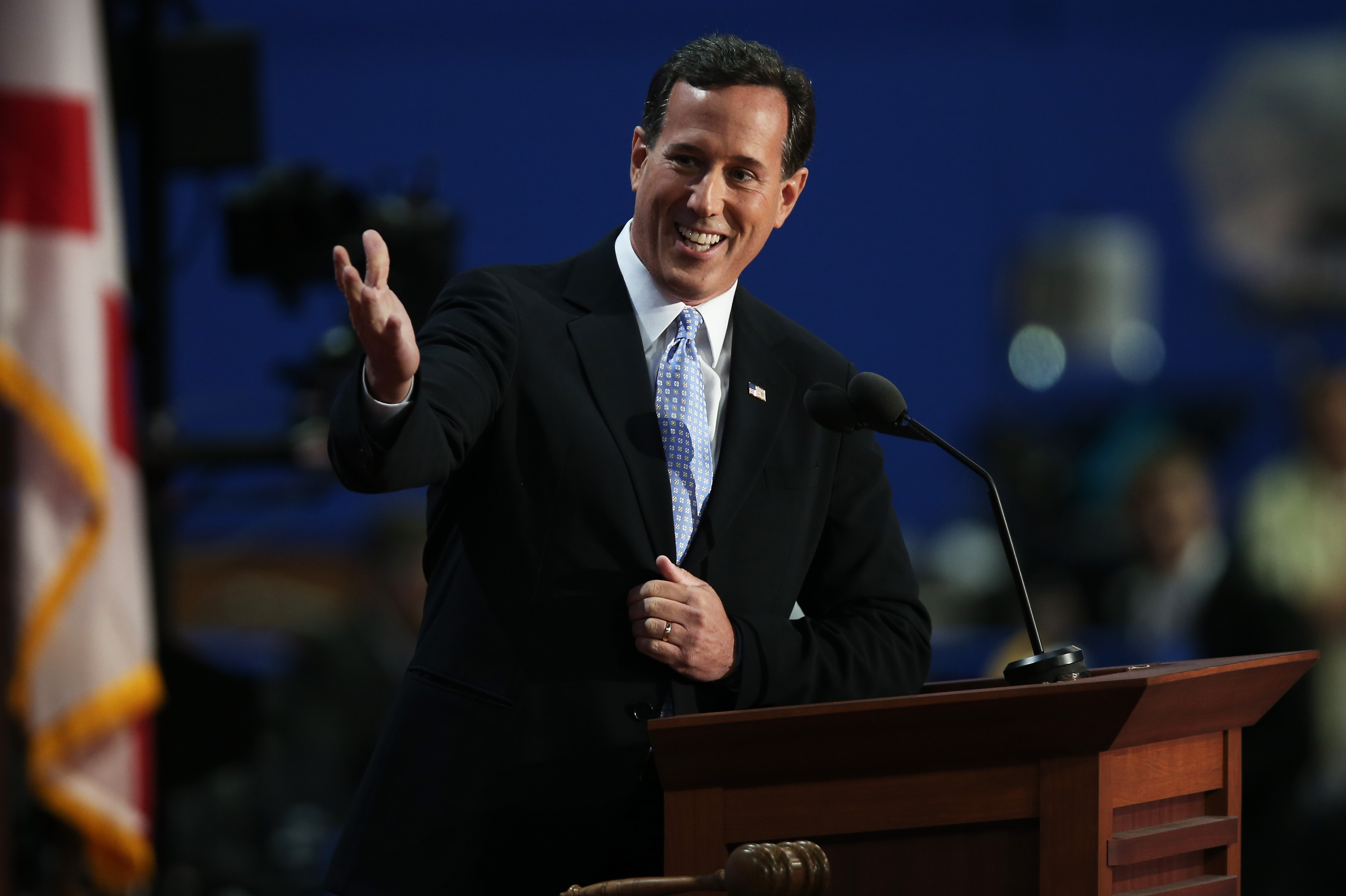Former Pennsylvania Sen. Rick Santorum addresses the Republican National Convention in Tampa, Fla., on Tuesday. "Under President Obama," Mitt Romney's former rival said, "the dream of freedom and opportunity has become a nightmare of dependency with almost half of America receiving some government benefit." Mitt Romney, he said, would change that.
