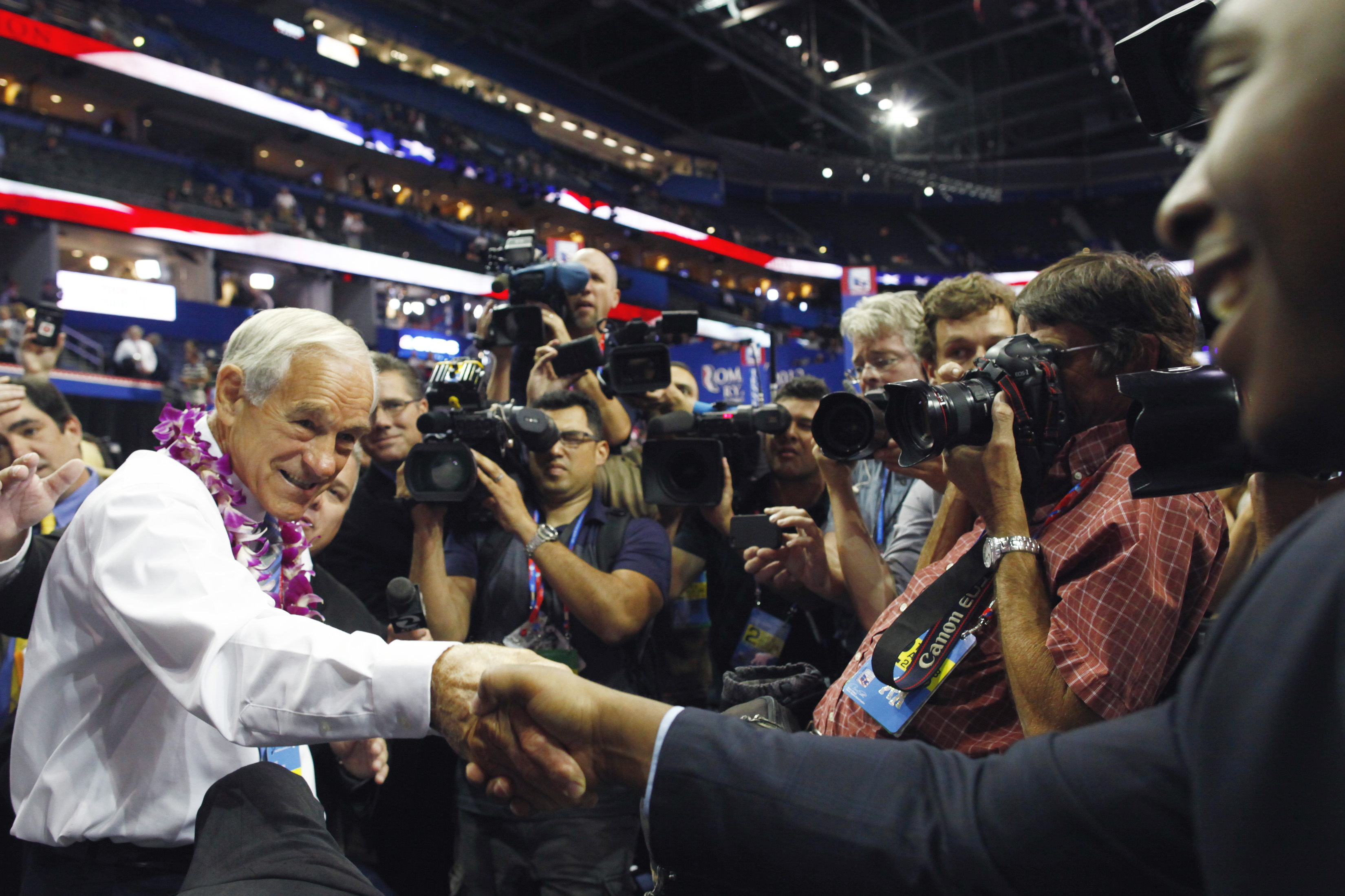 Texas Rep. Ron Paul greets convention goers. Paul supporters booed loudly and chanted against new rules adopted Tuesday that determine how delegates are apportioned in each state.
