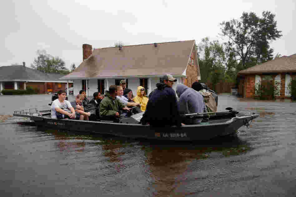 Rescue workers transport residents trapped by rising water from Hurricane Isaac in the River Forest subdivision on Wednesday in LaPlace, Louisiana. The large Level 1 hurricane slowly moved across southeast La., dumping huge amounts of rain and knocking out power across the Gulf Coast.