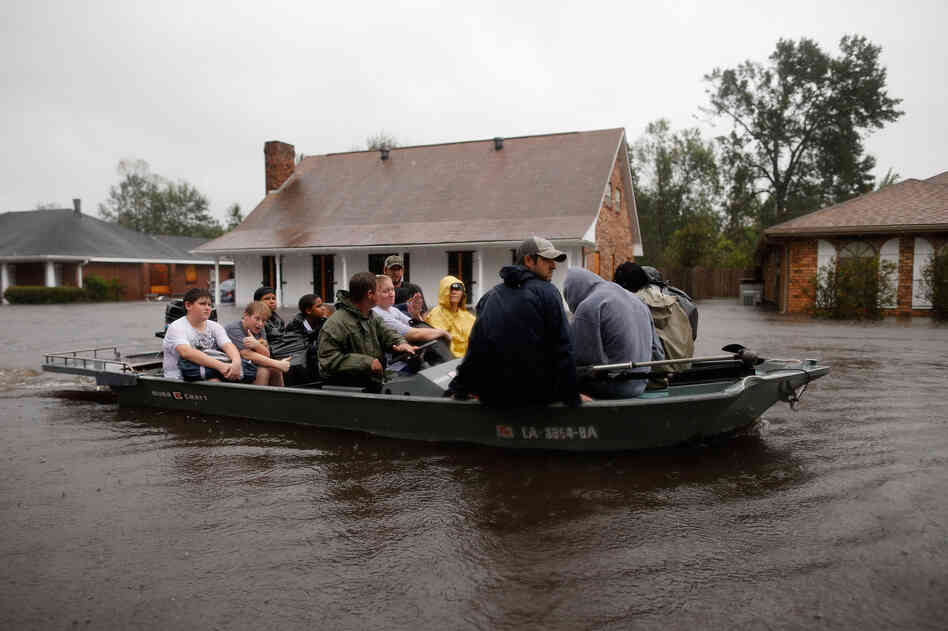 Rescue workers transport residents trapped by rising water from Hurricane Isaac in the River Forest subdivision on Wednesday in LaPlace, Louisiana. The large Level 1 hurricane slowly moved across southeast La., dumping huge amounts of rain and knocking out power across the Gulf Coast.