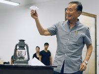 Takei rehearses a scene in which his character, Ojii-San, tries to cheer his granddaughter up by making her an origami flower out of a loyalty questionnaire.