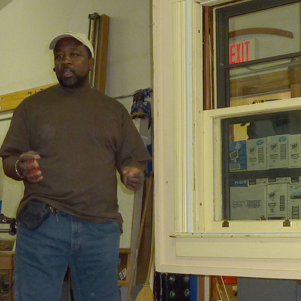 Pernell Jackson teaches a workshop on how to install storm windows.