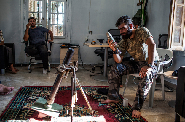 The Syrian rebels have no one source for their weapons and have had to scrape together their arsenal in various ways. Here, Abdel Hakim Yassin, a rebel commander in northern Syria, inspects a Yugoslav illumination mortar round that was brought to him by an Iraqi arms dealer.