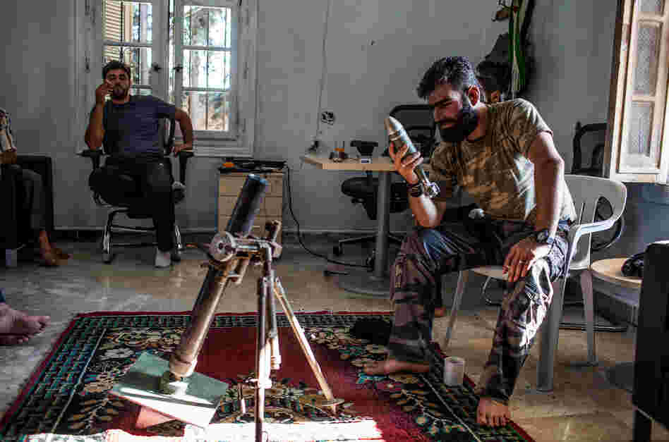 The Syrian rebels have no one source for their weapons and have had to scrape together their arsenal in various ways. Here, Abdel Hakim Yassin, a rebel commander in northern Syria, inspects a Yugoslav illumination mortar round that was brought to him by an Iraqi arms dealer.