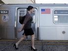 A commuter walks down the platform before boarding a Manhattan-bound N train at Astoria-Ditmars Boulevard station in the Queens borough of New York. A commuter walks down the platform before boarding a Manhattan-bound N train at Astoria-Ditmars Boulevard station in the Queens borough of New York.