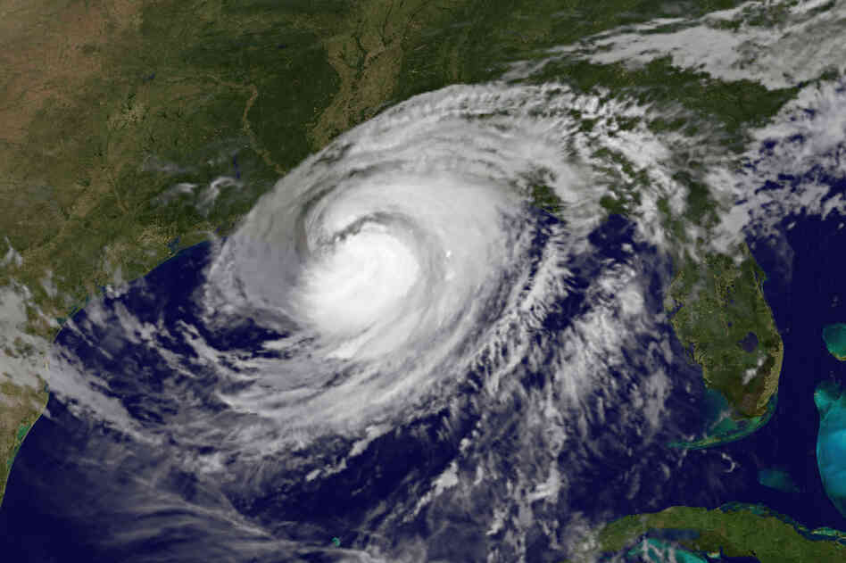 This satellite image shows Hurricane Isaac over the Gulf of Mexico and the Gulf states Wednesday. Rising waters spilled over a levee south of New Orleans and inundated a residential area that had been ordered evacuated.