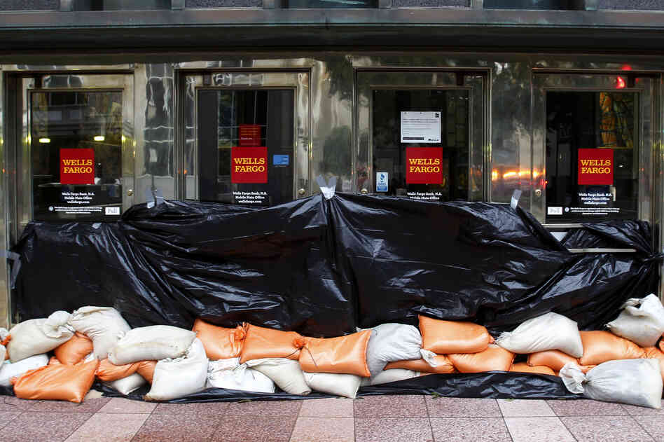 Sand bags block the entrance to a Wells Fargo bank in Mobile, Ala.