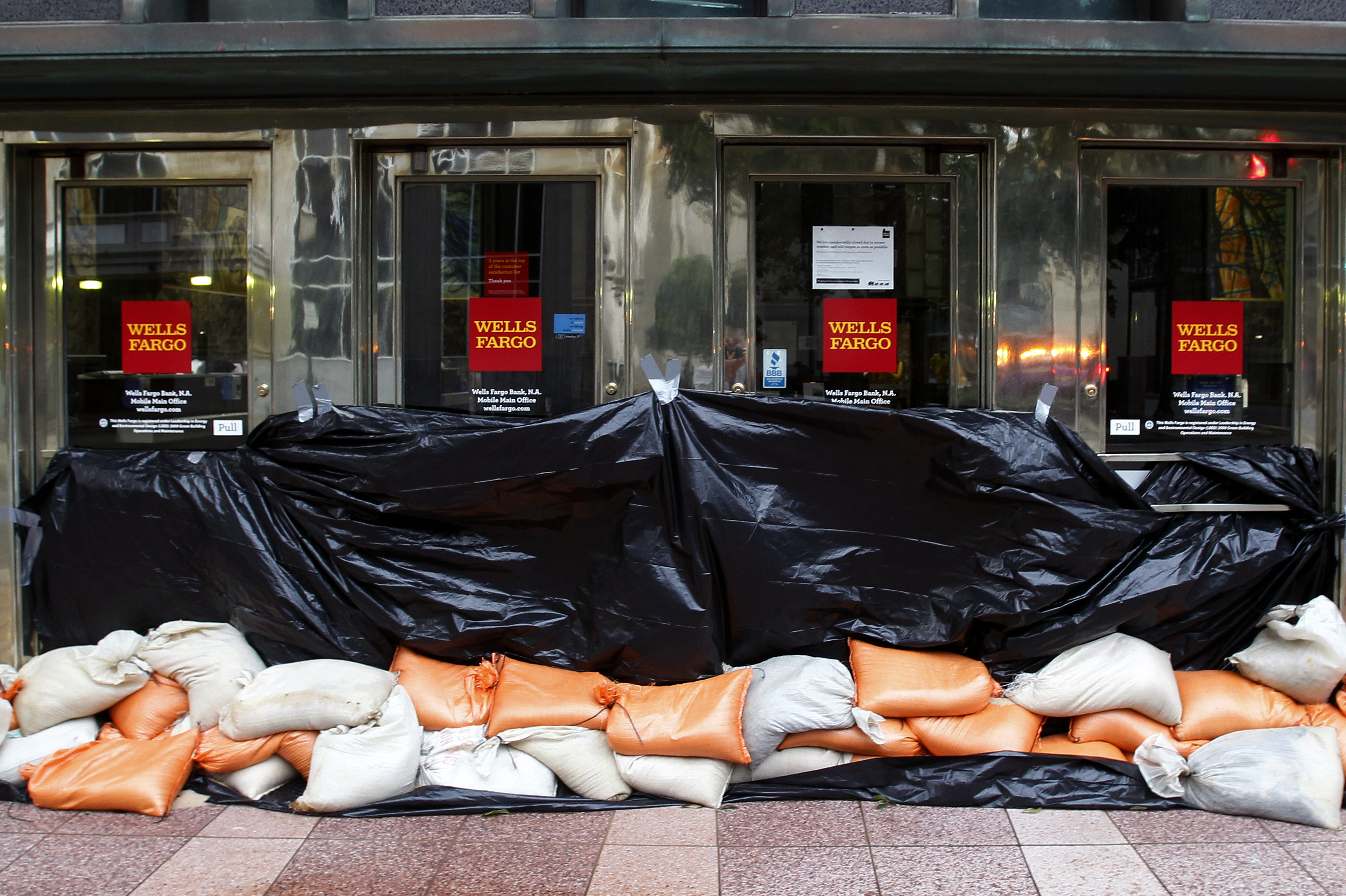Sand bags block the entrance to a Wells Fargo bank in Mobile, Ala.