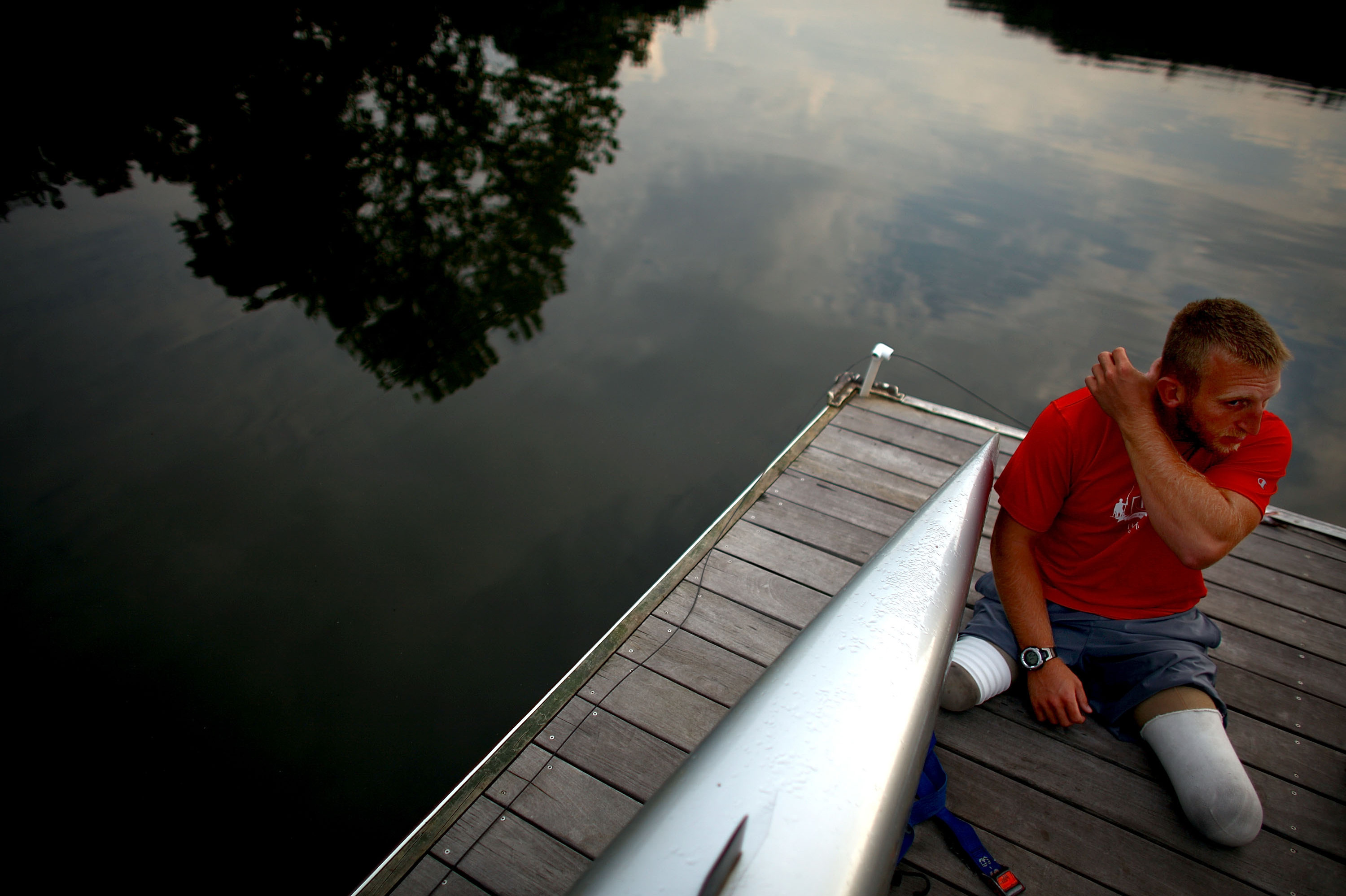Jones sits on the dock at the Rivanna Reservoir before putting his boat in the water. The Paralympic movement began half a century ago when disabled vets from World War II started looking for a way to continue active lifestyles.